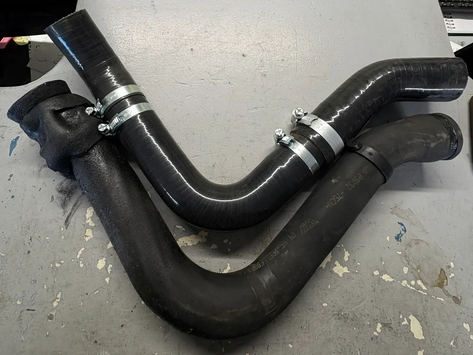 Durites silicone montées sur leurs raccords avec colliers de serrage, sur l’établi
